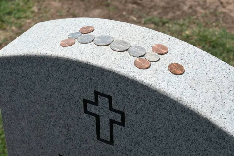 coins on gravestone